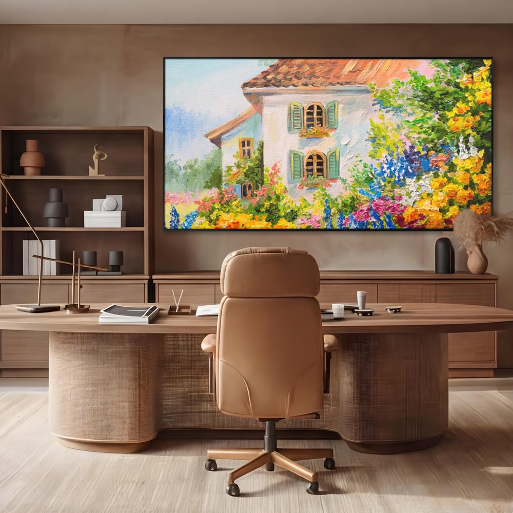Tablou canvas cu pictura cu casa alba si flori, in rama de aluminiu negru, pe perete intr-un birou